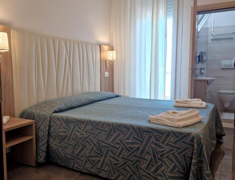 Cozy room with a double bed and bright bathroom.