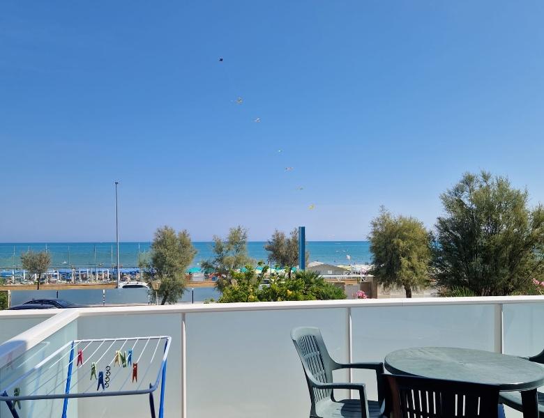Sea view from a sunny balcony, clear sky and summer relaxation.