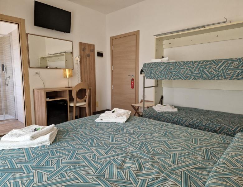 Bright room with bunk beds, modern bathroom, and stylish furnishings.